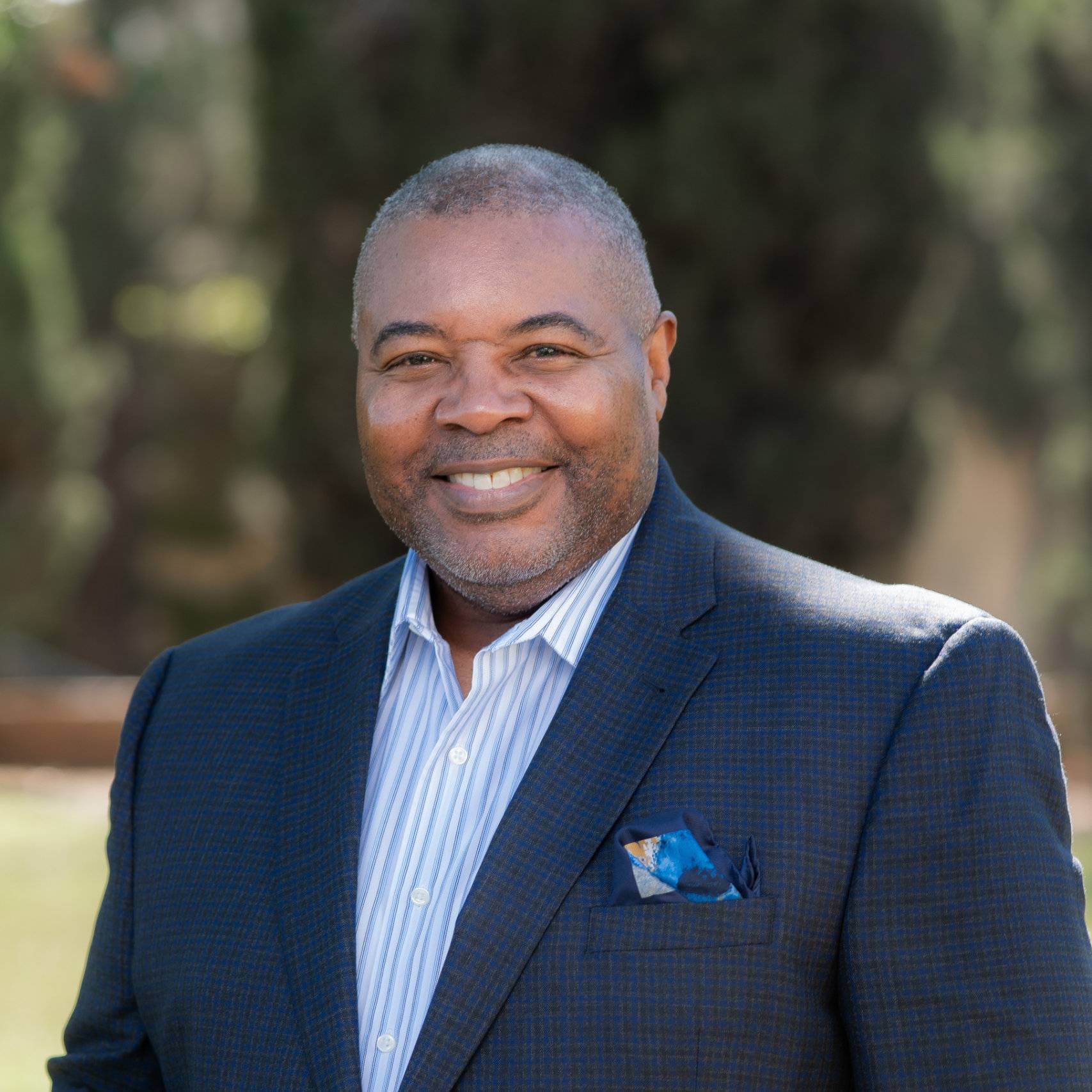 a person in a suit smiling