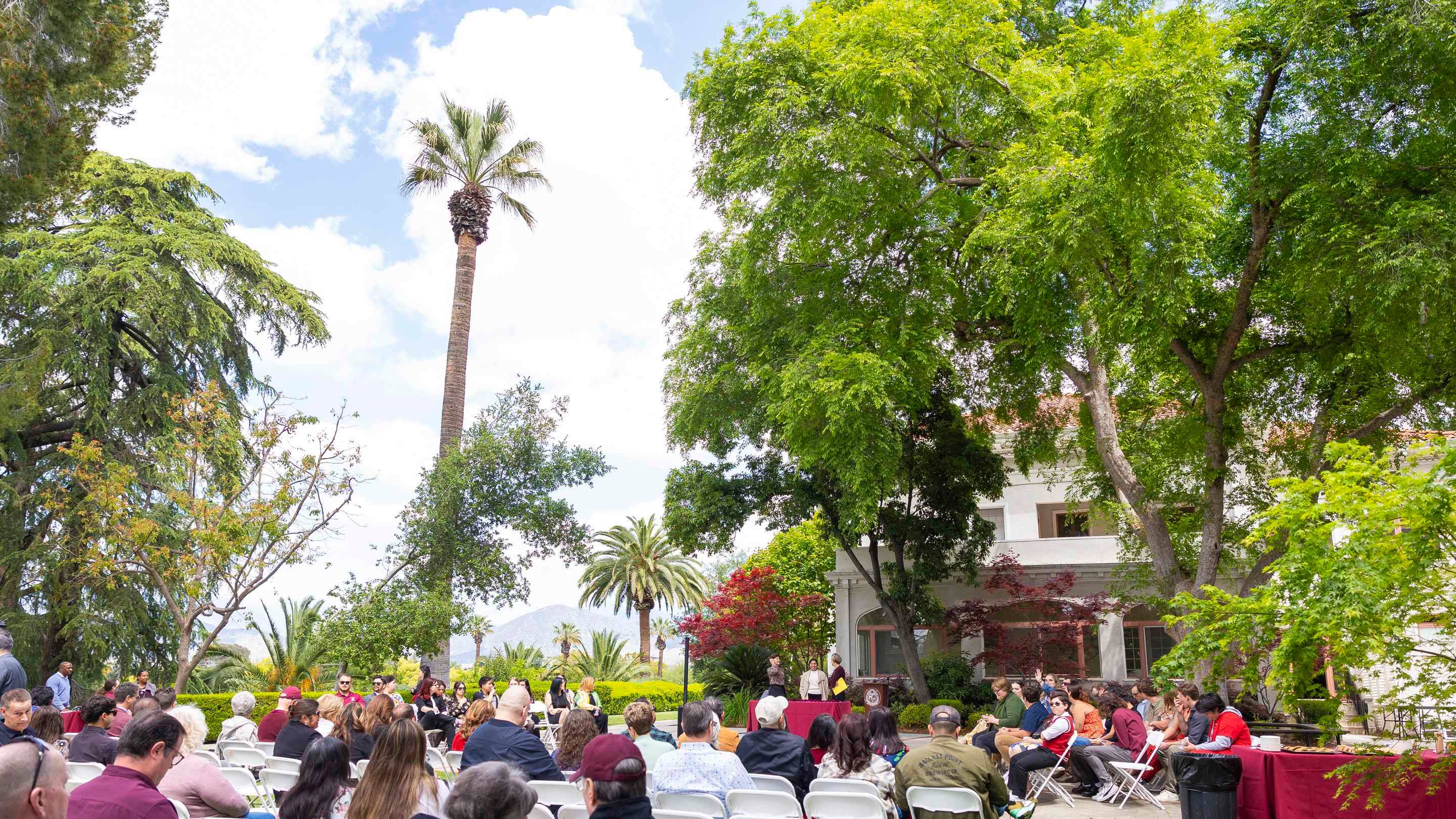a group of people sitting in chairs outside