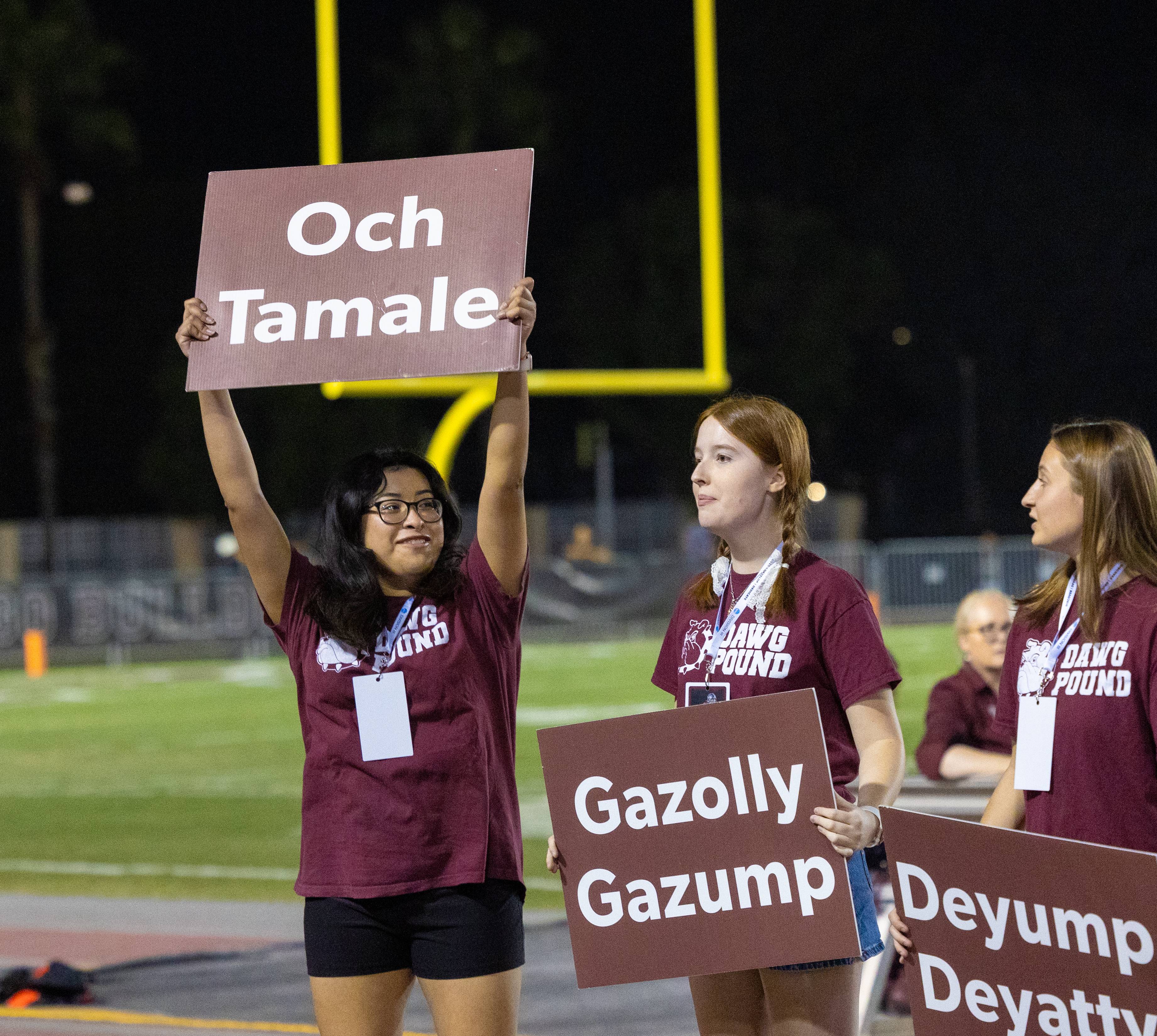 a group of women holding signs