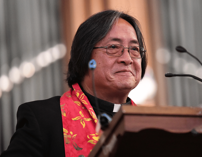 a person in glasses and a red scarf