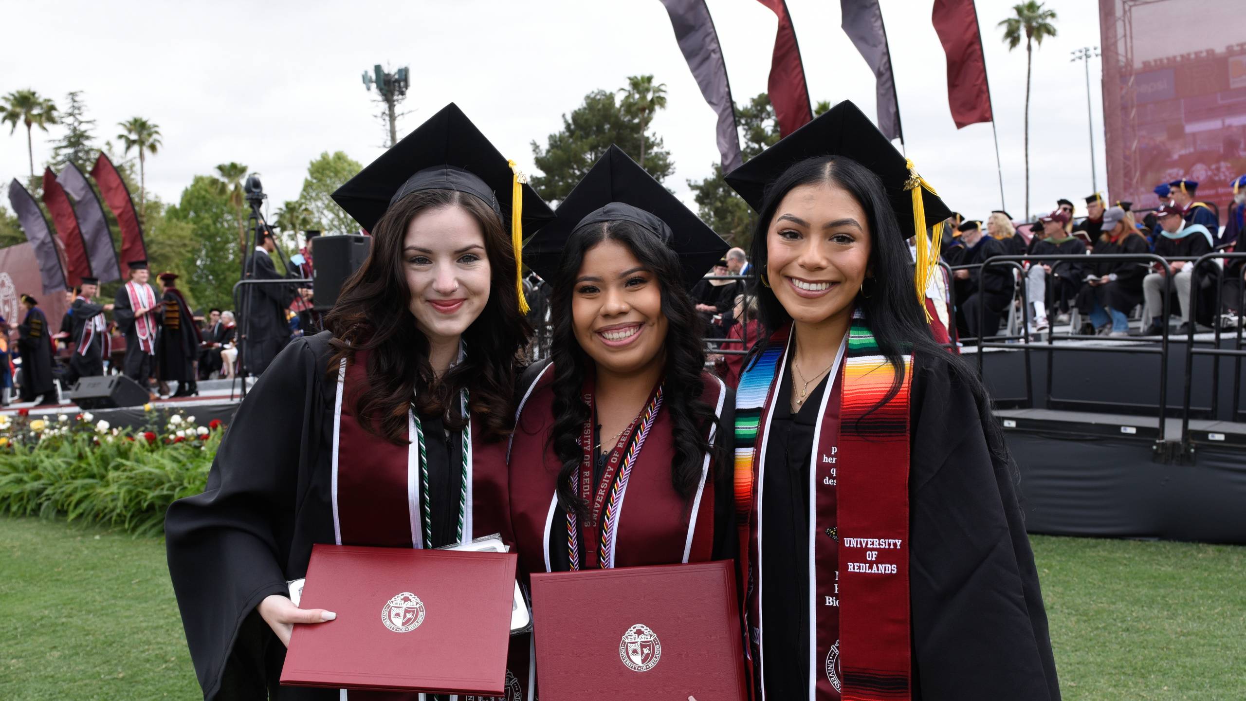 a group of women in graduation gowns and caps