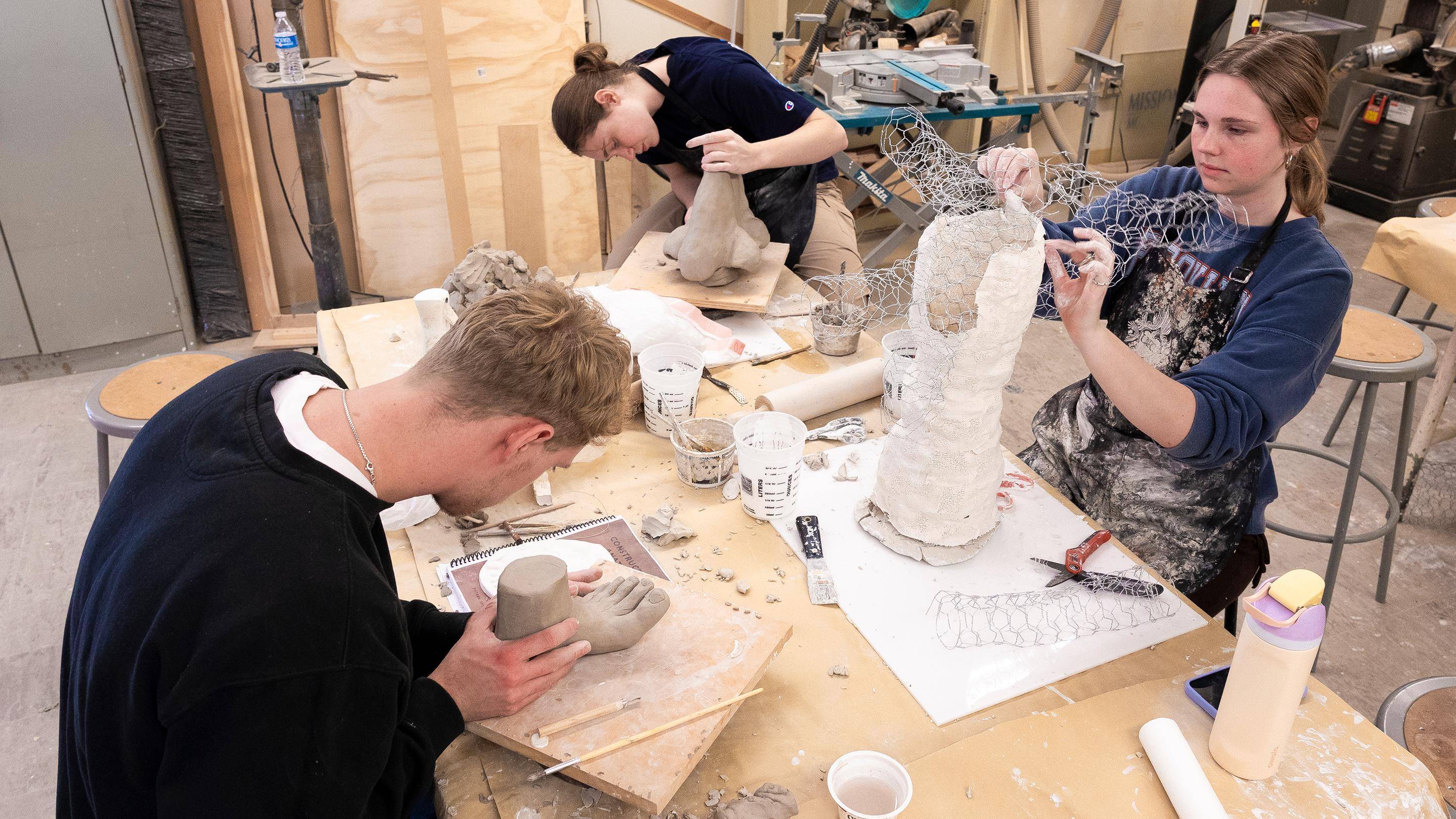 a group of people working on a sculpture