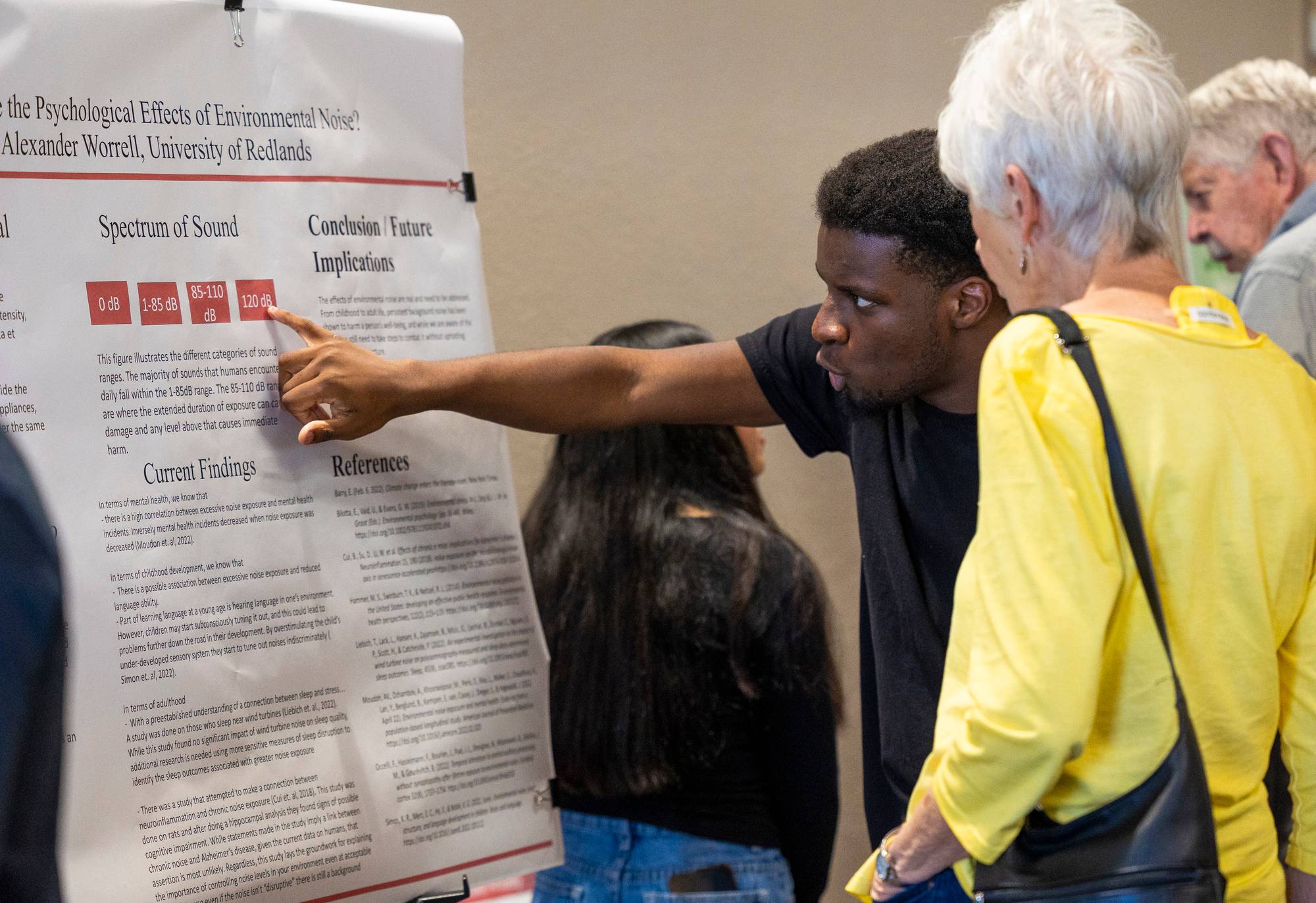 a person pointing at a poster