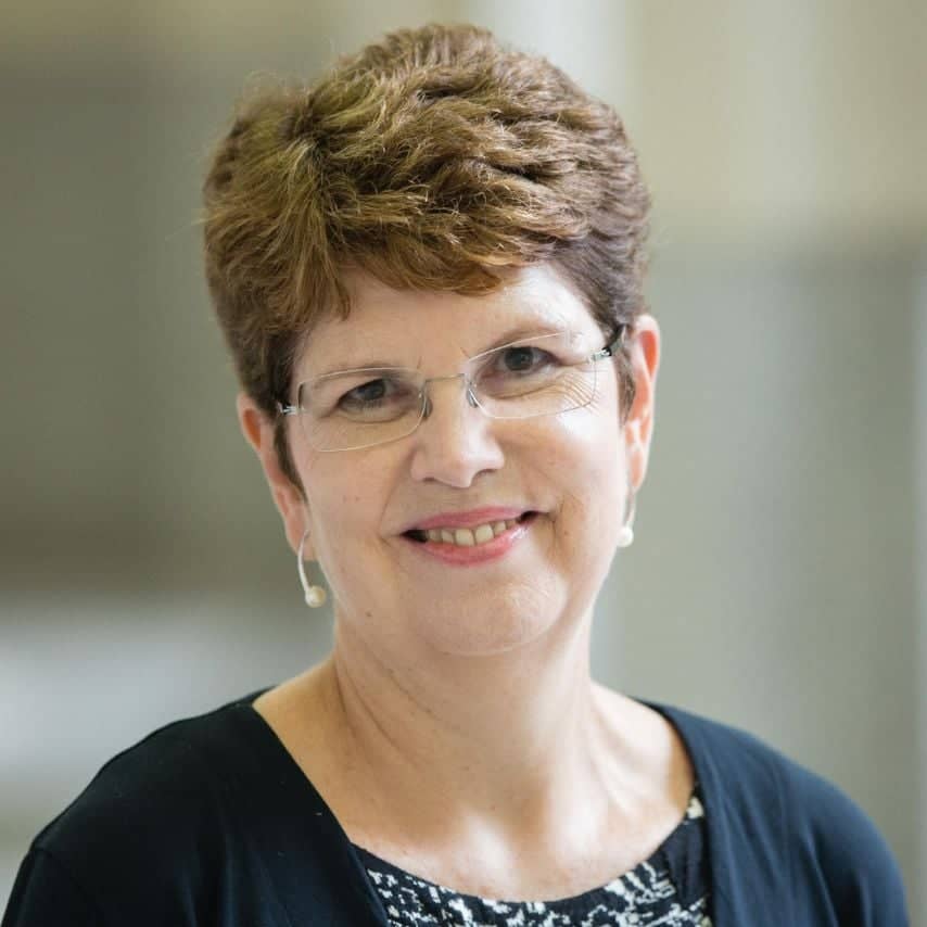 a person with short hair wearing glasses
