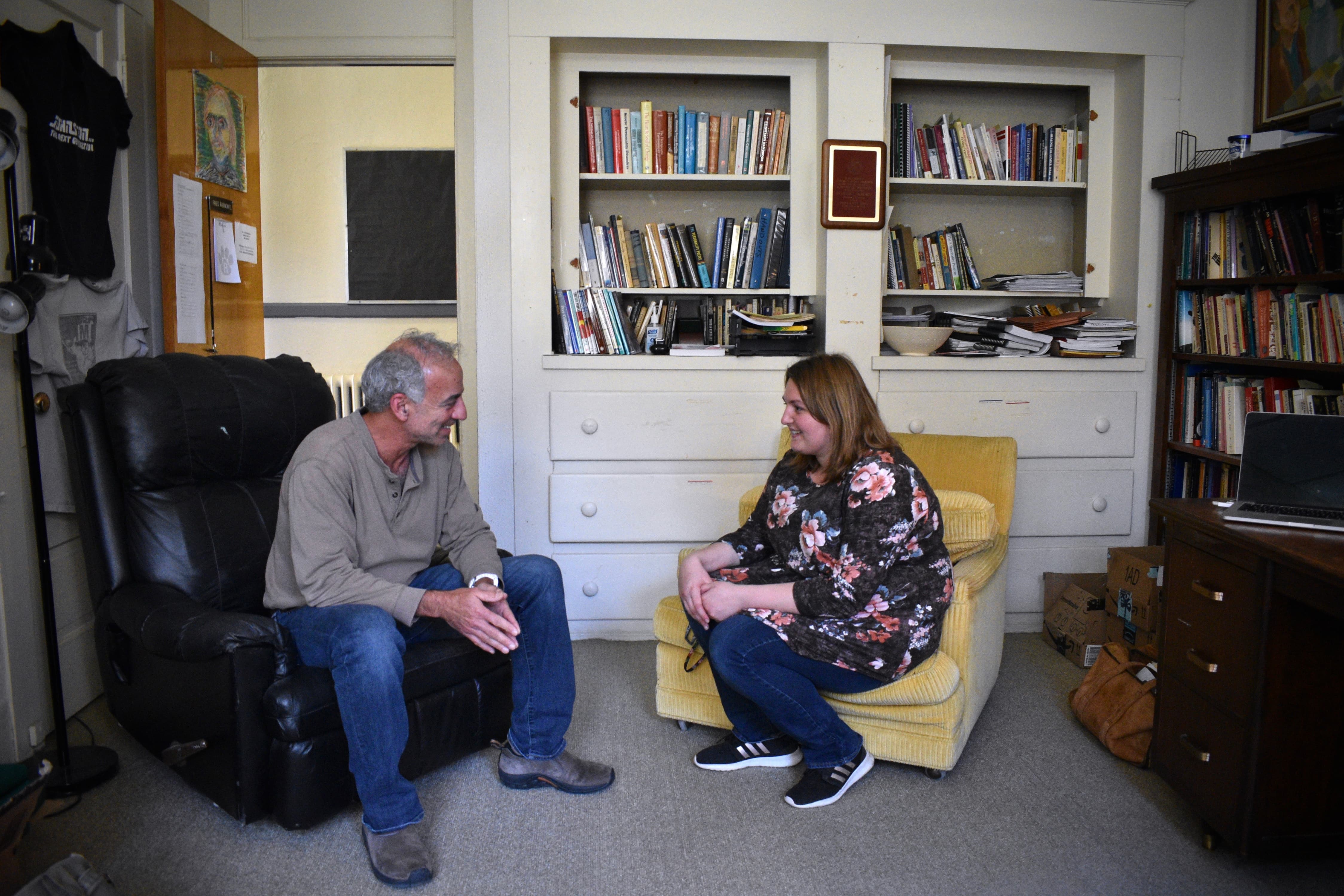 a person and person sitting in chairs and talking