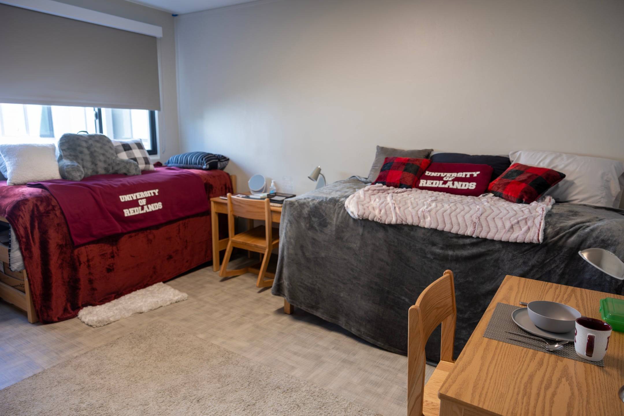 a room with two beds and a table