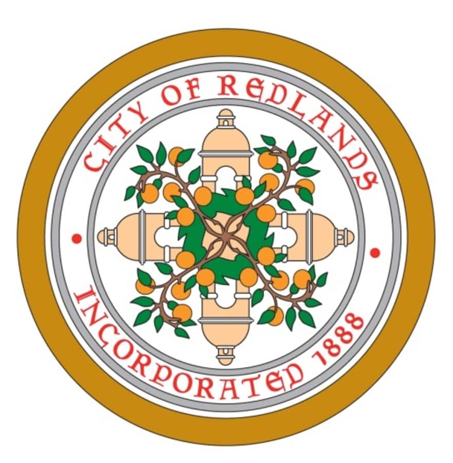 a circular logo with oranges and text