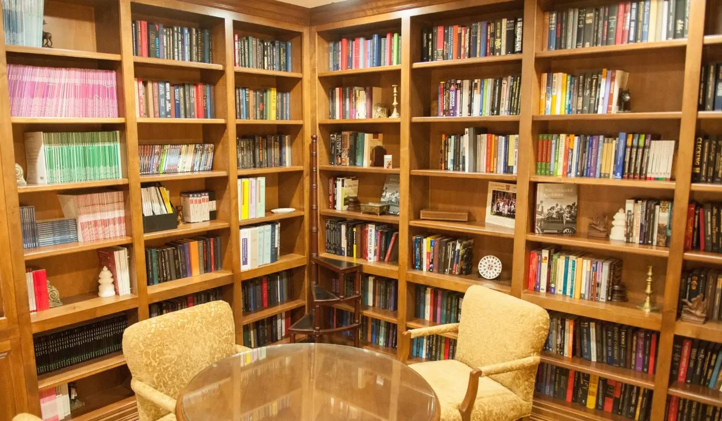 a room with bookshelves and chairs