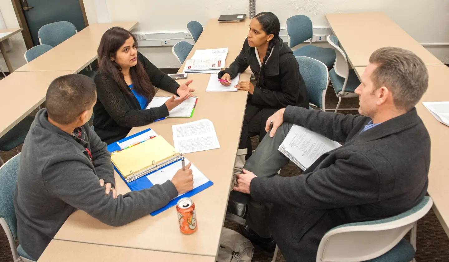 a group of people sitting around a table