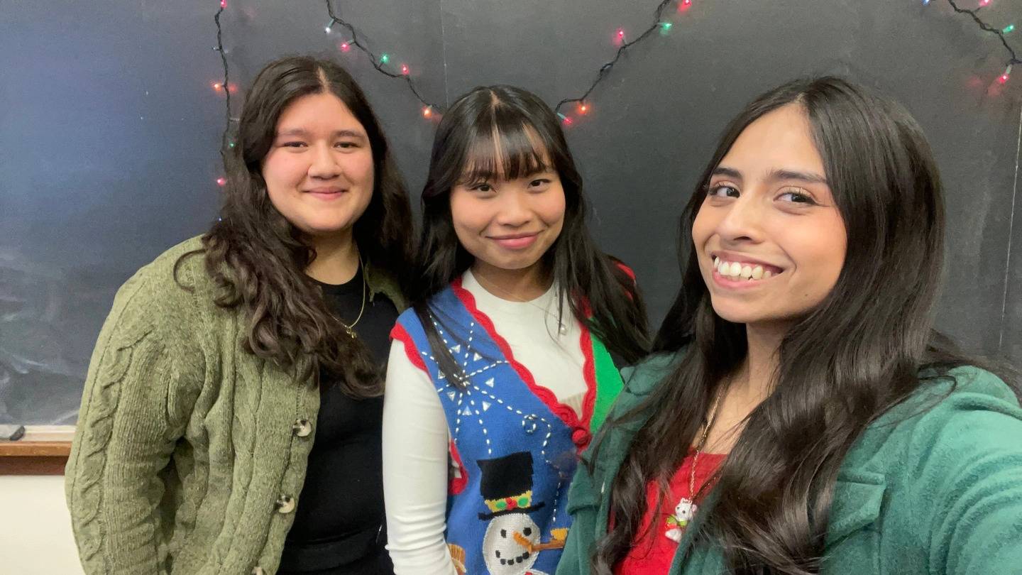 Three students smiling for a photo