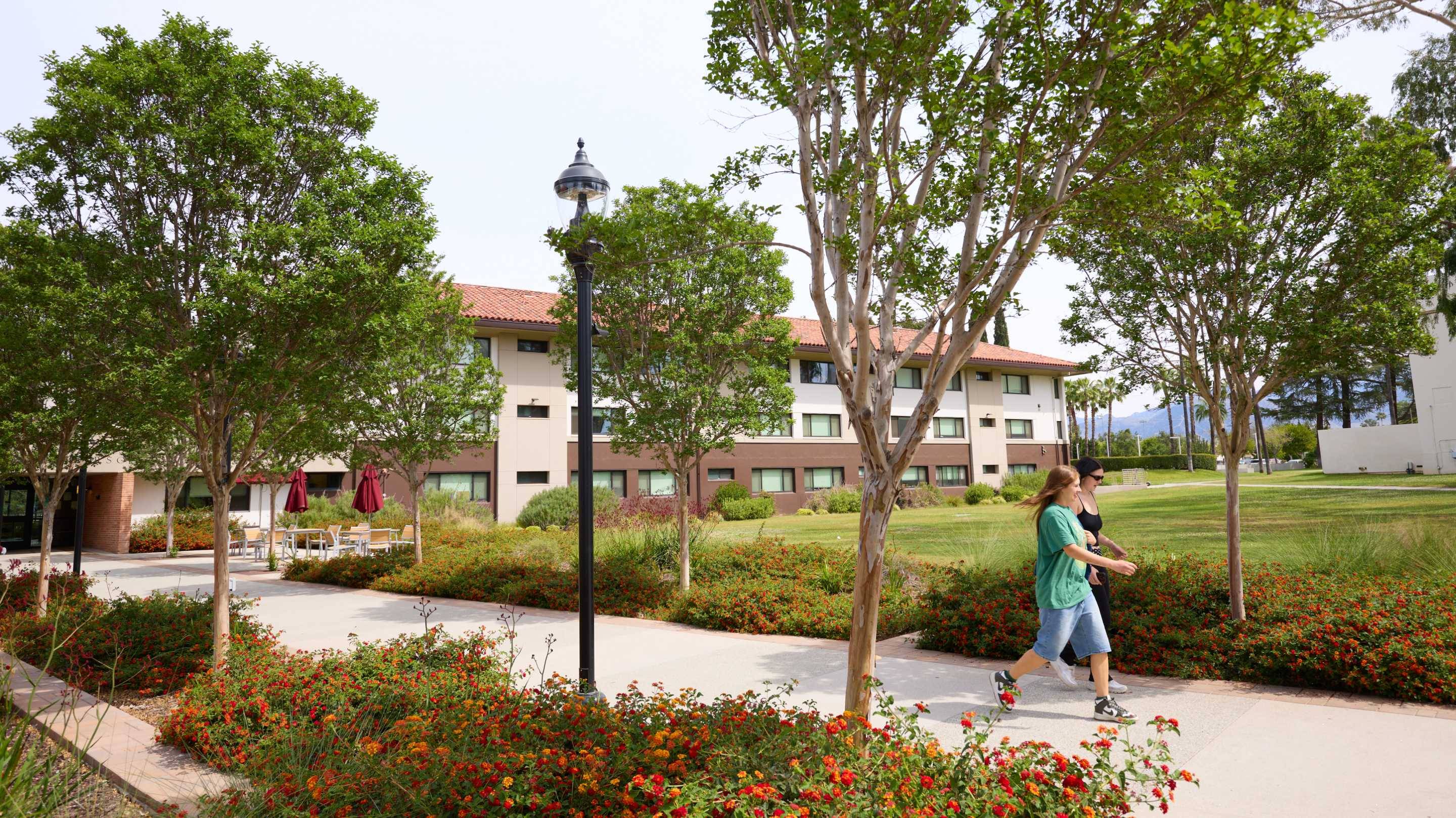a group of people walking on a sidewalk