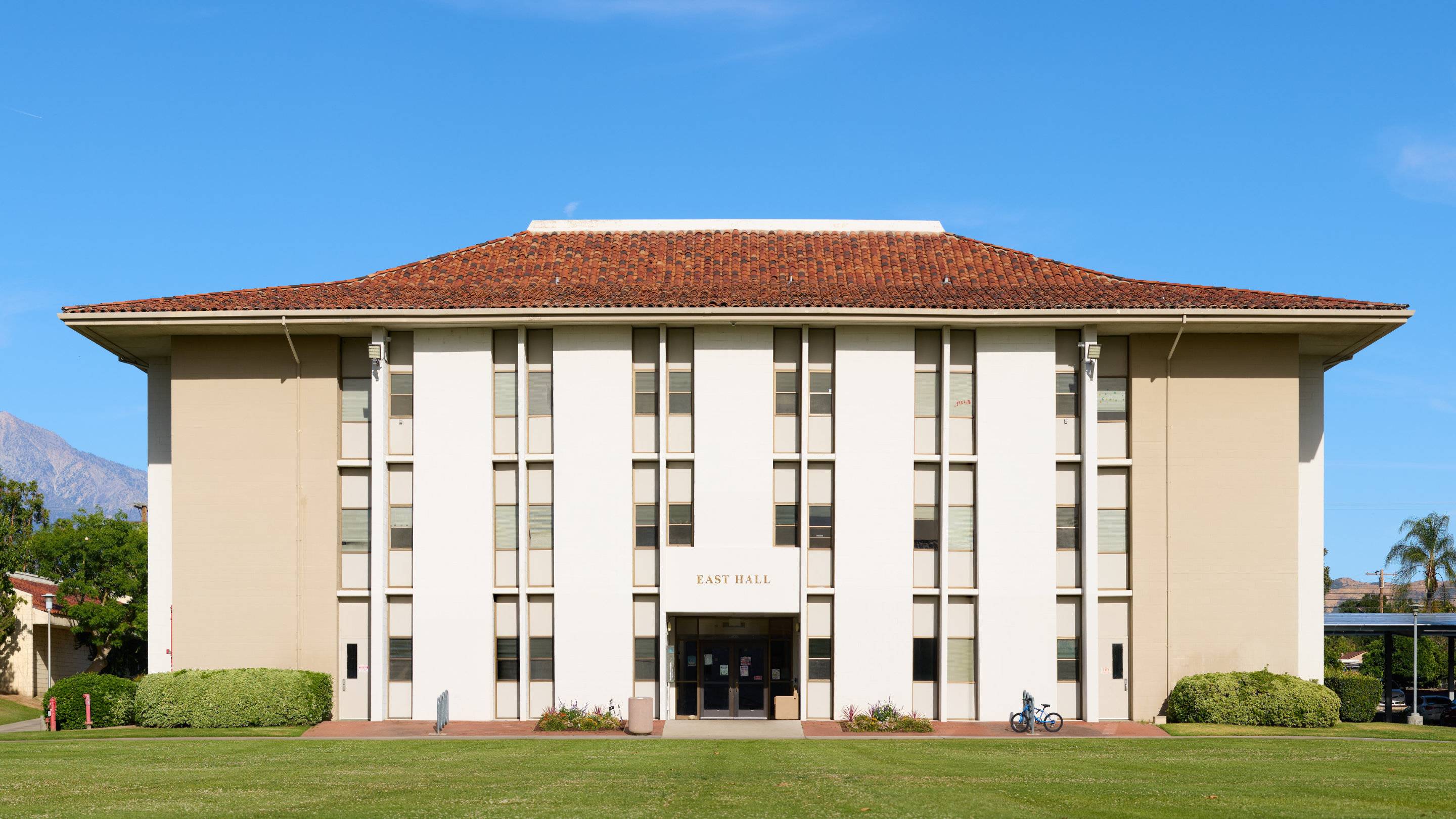 a building with a lawn and a bicycle