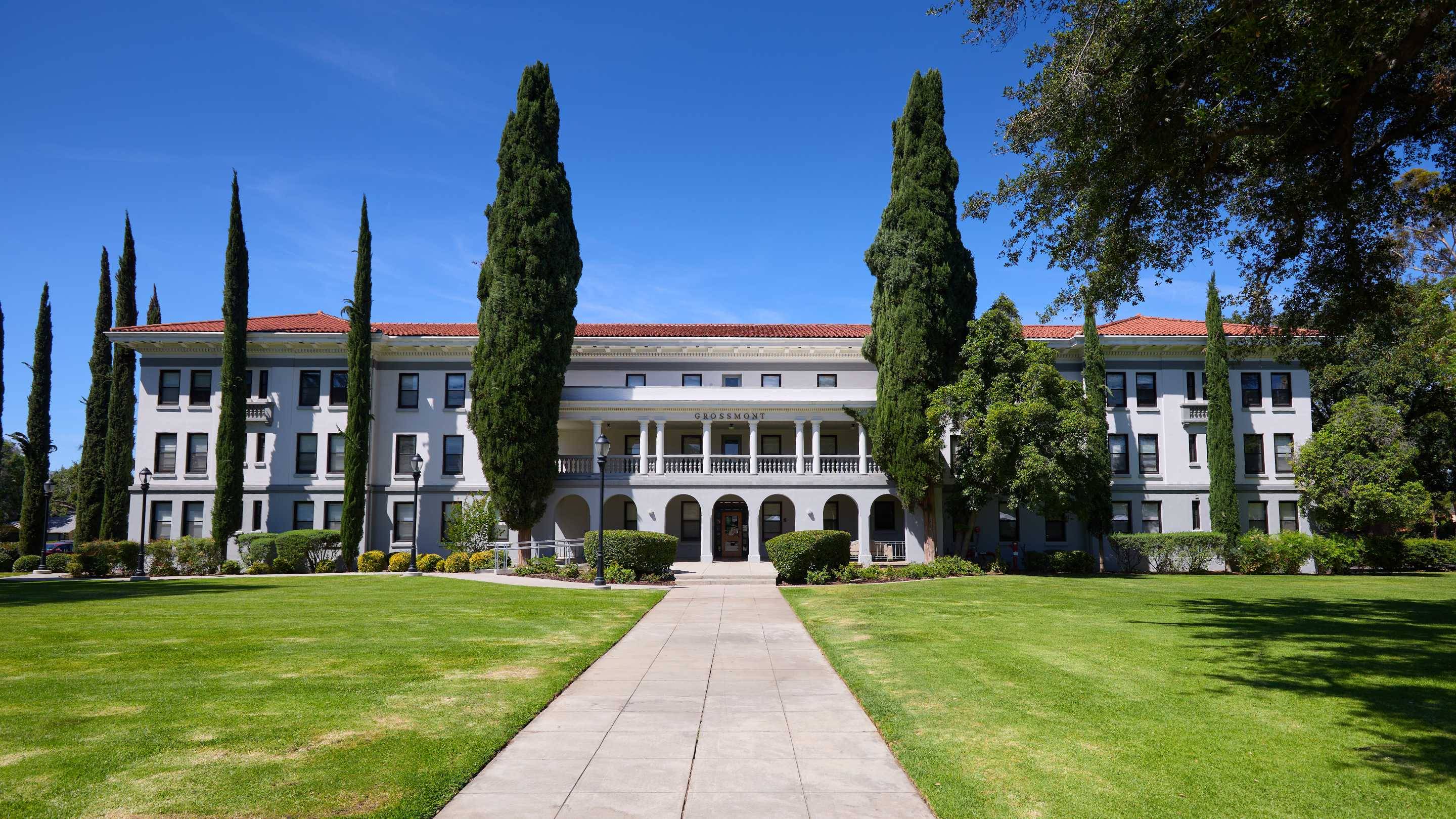 a building with trees and grass