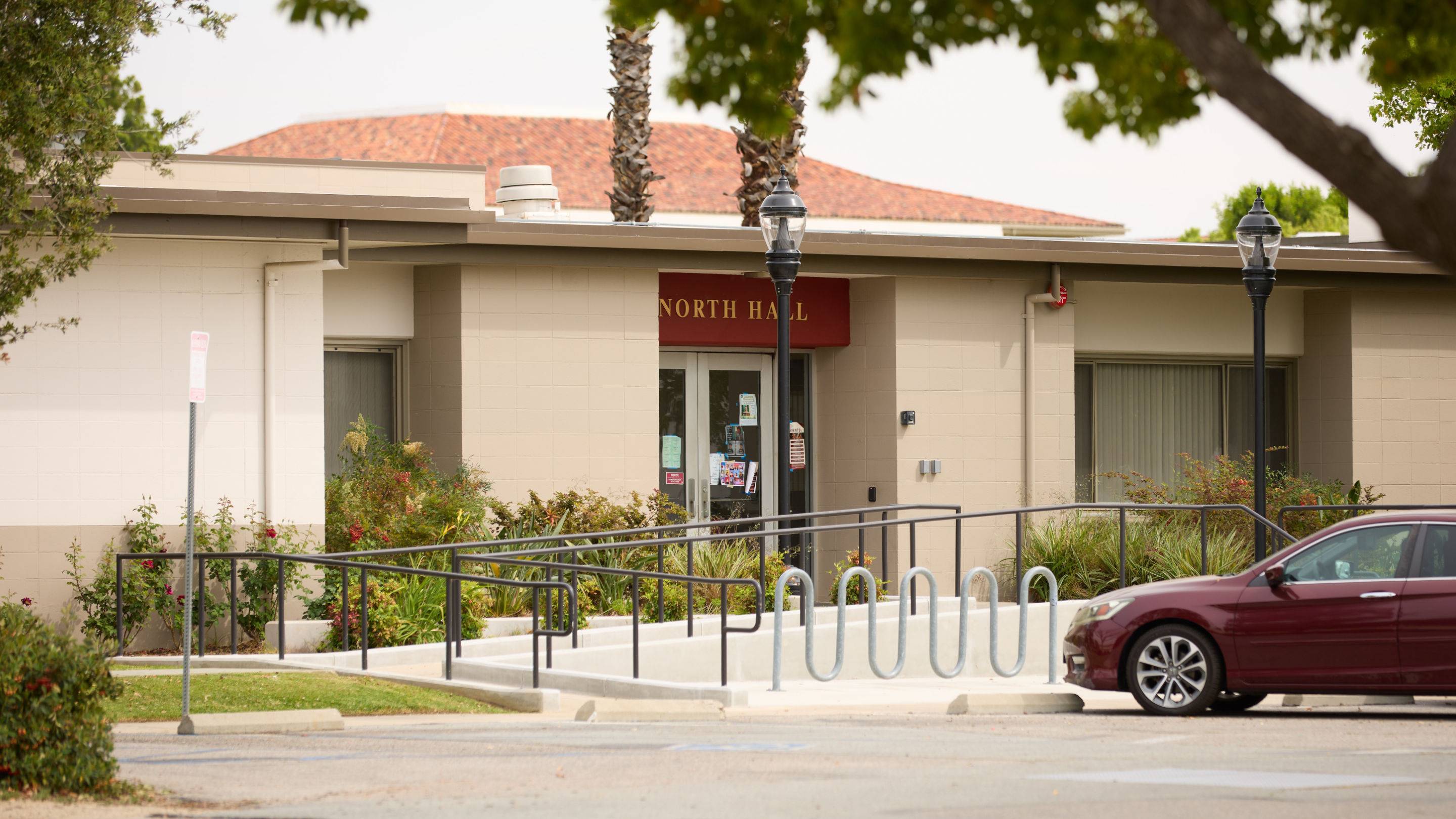 a building with a ramp and a car parked in front of it