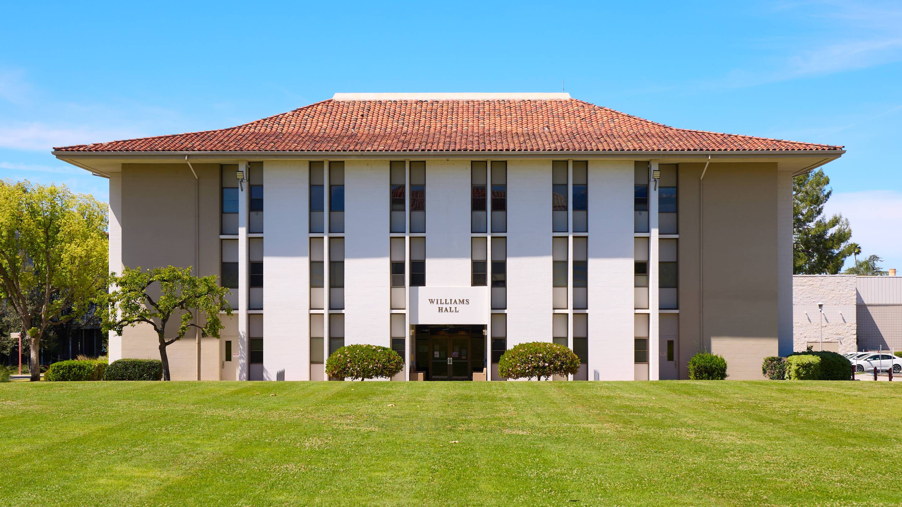 a building with a lawn and a blue sky