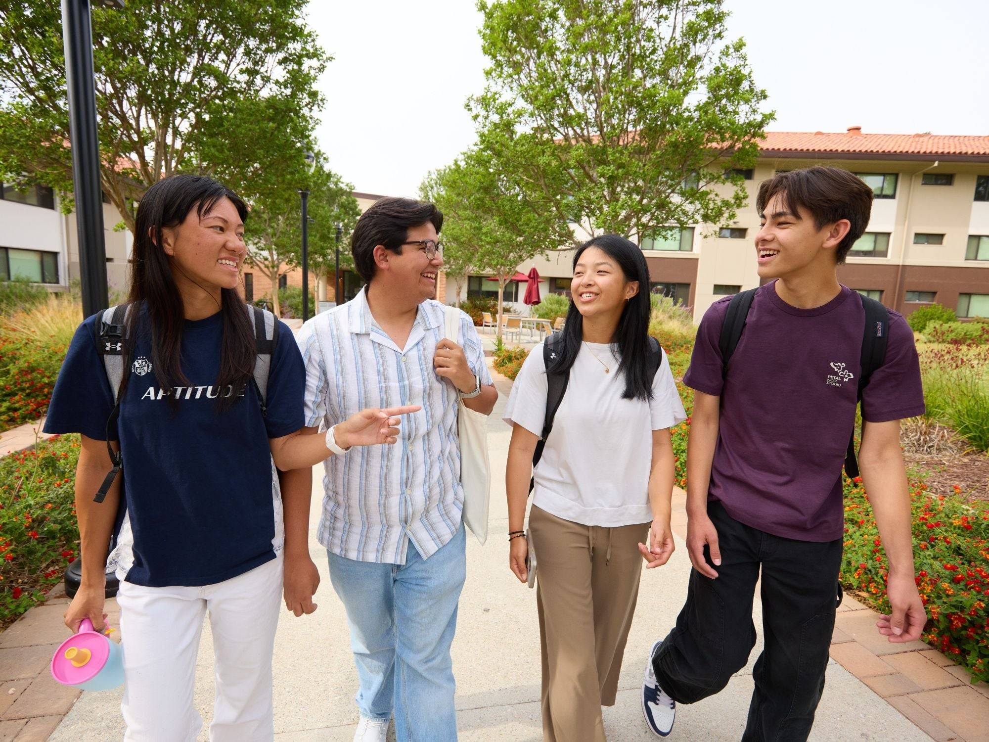 a group of people walking on a sidewalk
