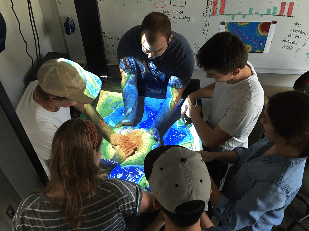 a group of people looking at a map