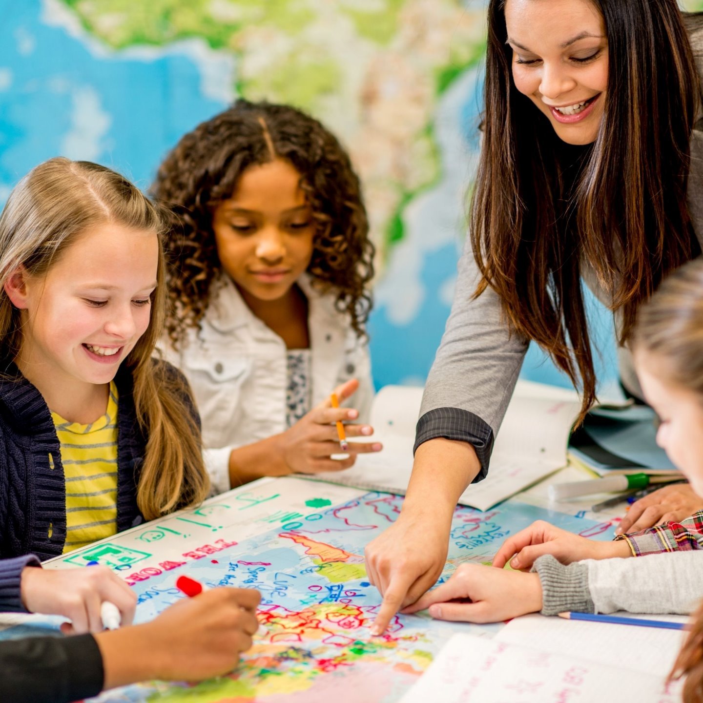 a group of children looking at a map