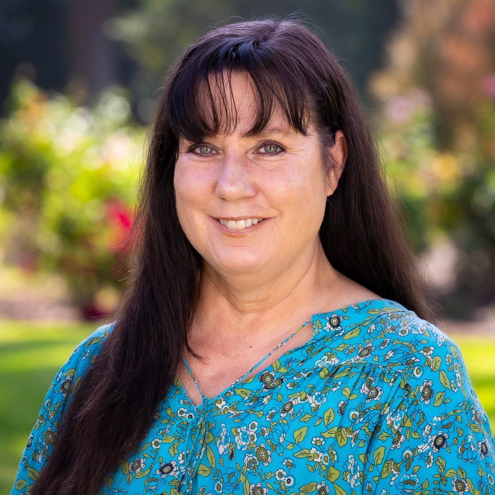 a woman with long hair wearing a blue shirt
