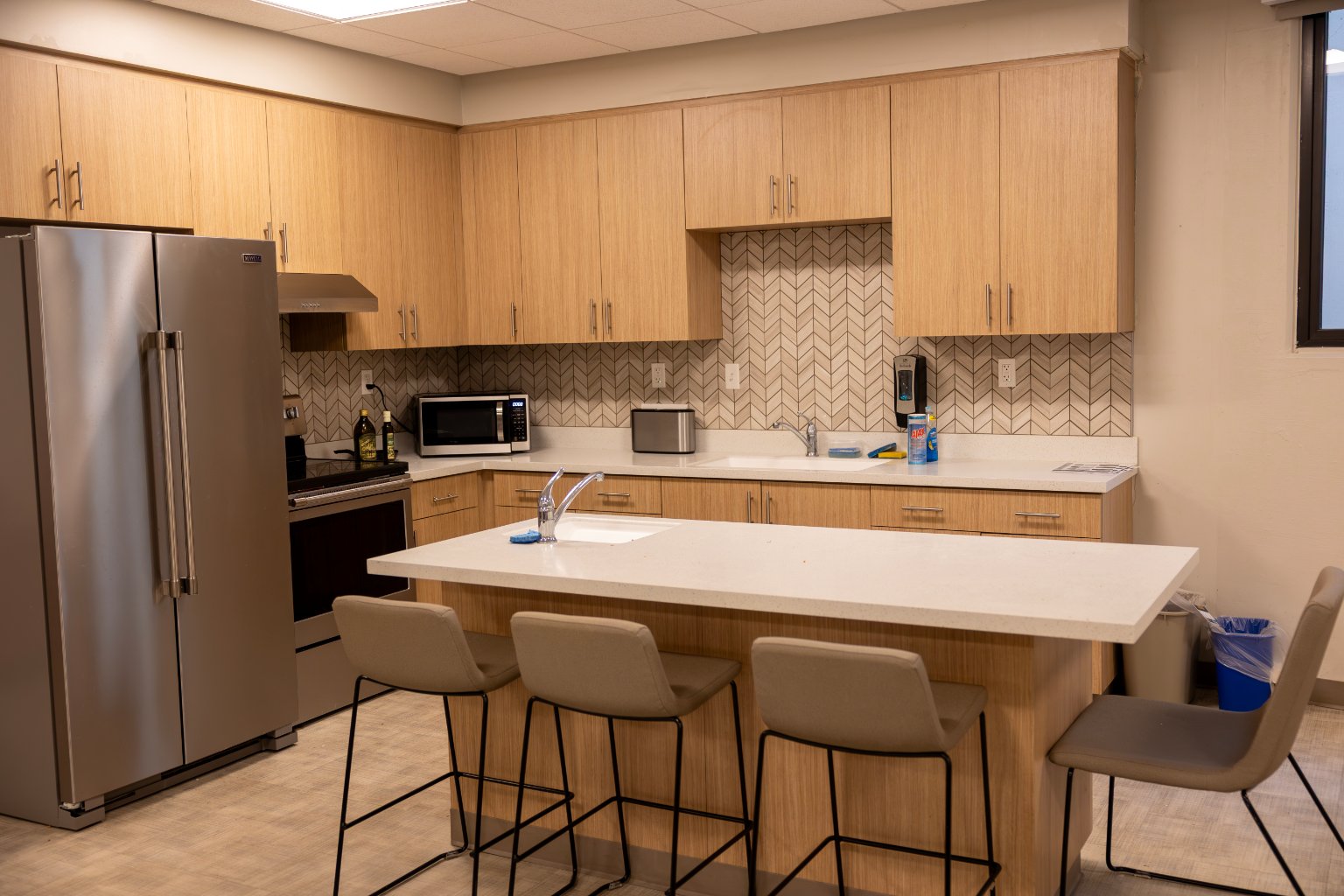 a kitchen with a counter top and chairs
