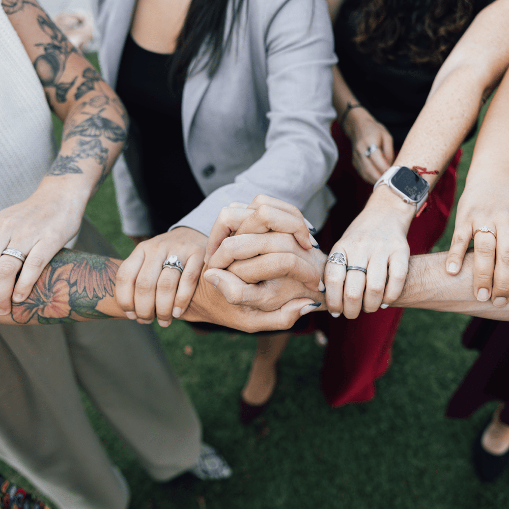 a group of people holding hands together