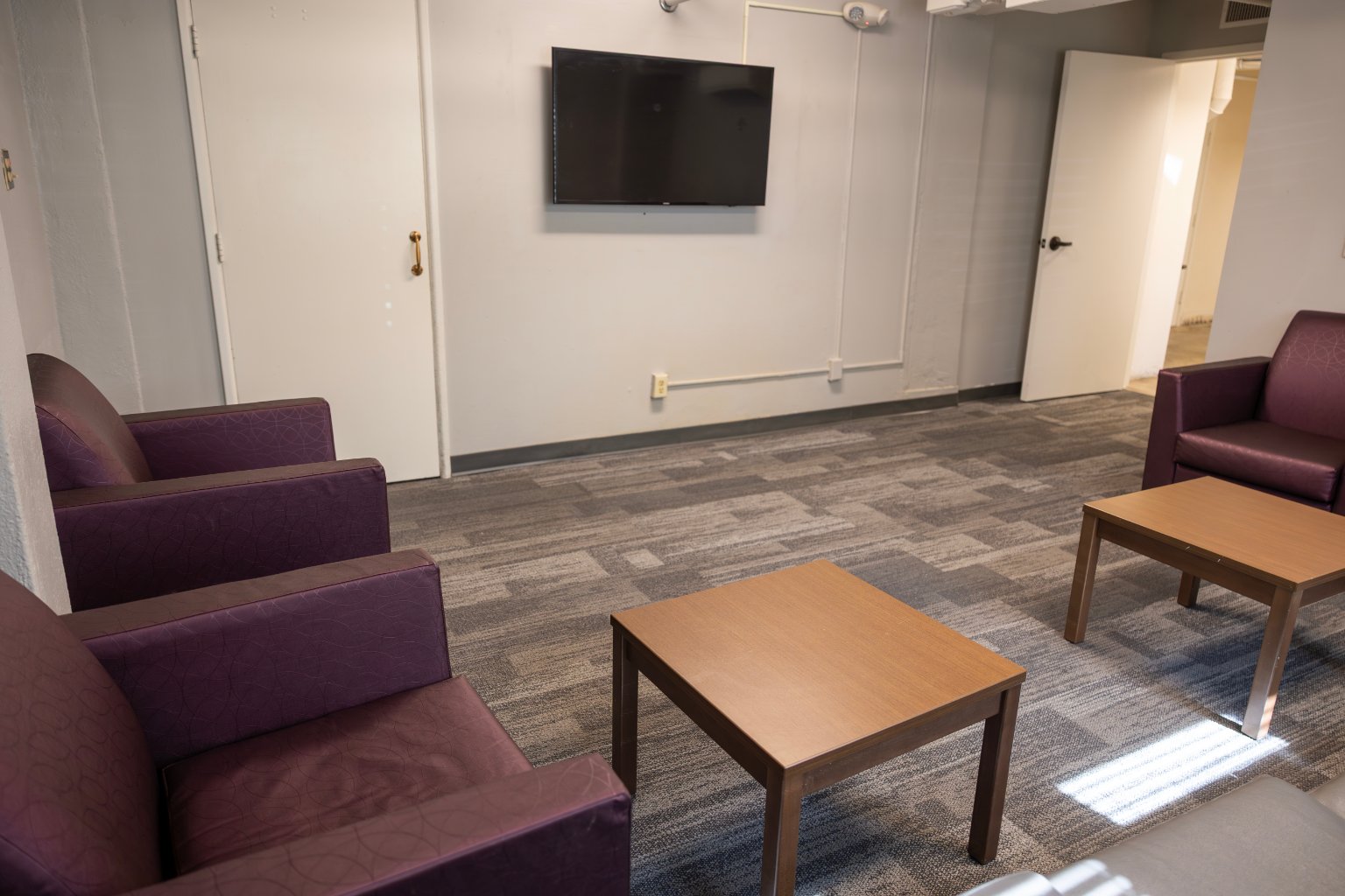 a room with a television on the wall