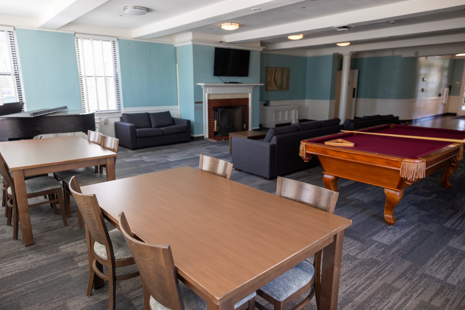 a room with a pool table and a fireplace