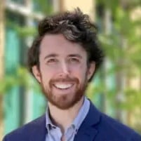 a man with a beard smiling