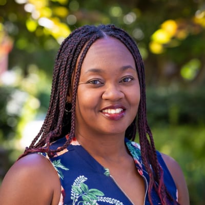 a woman with braided hair smiling