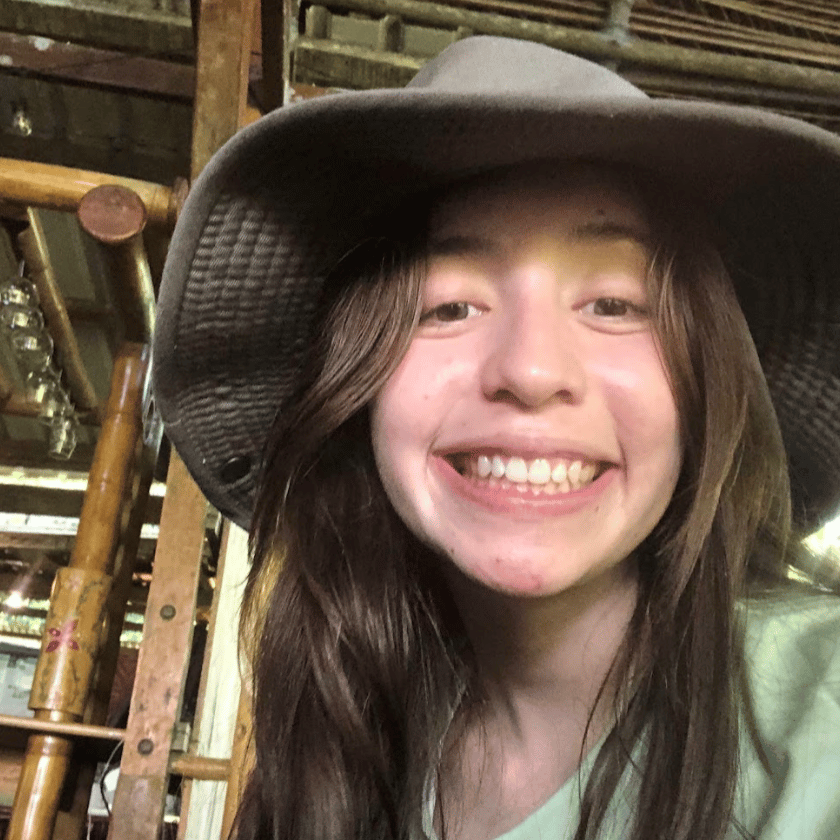 a girl wearing a hat smiling