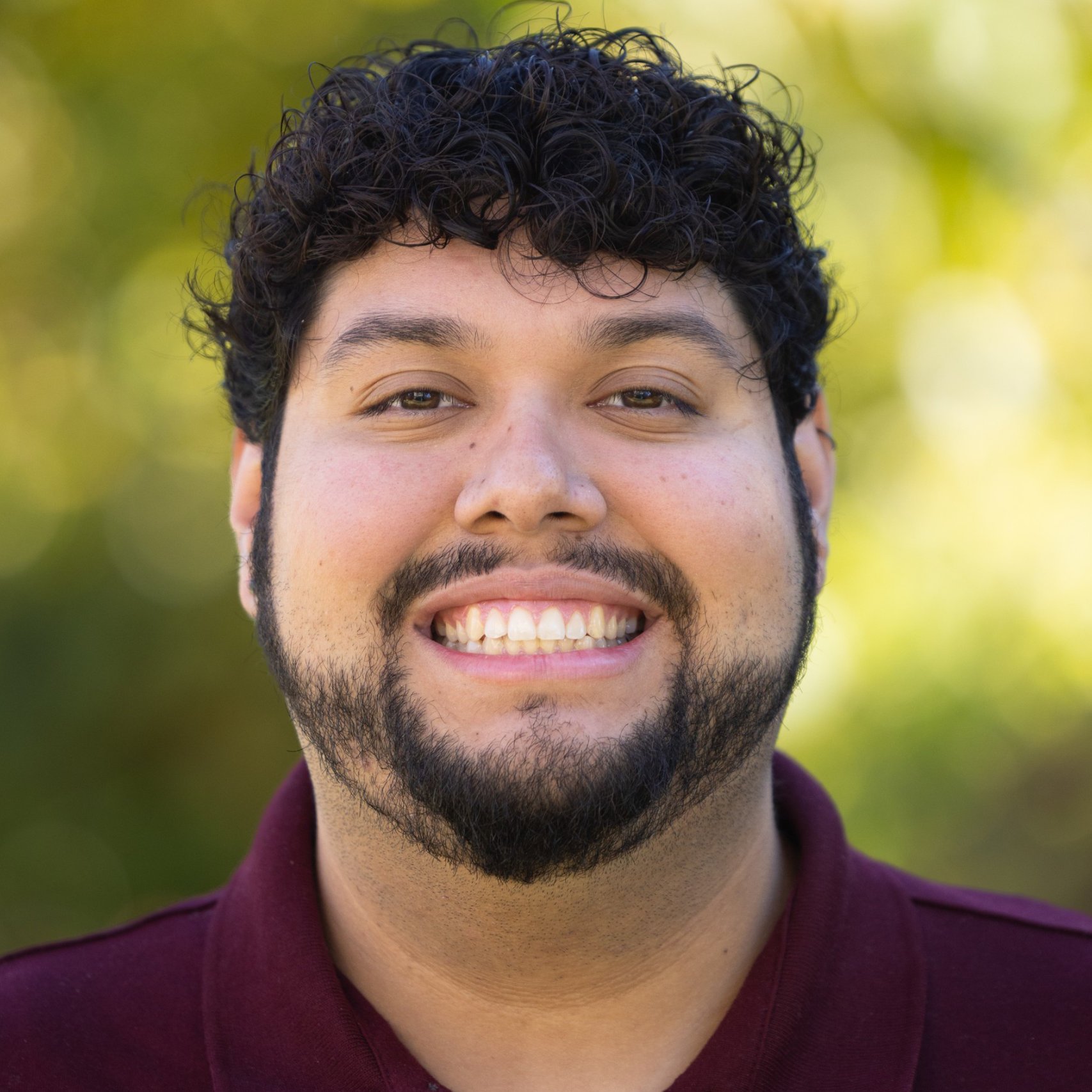 a person with a beard smiling
