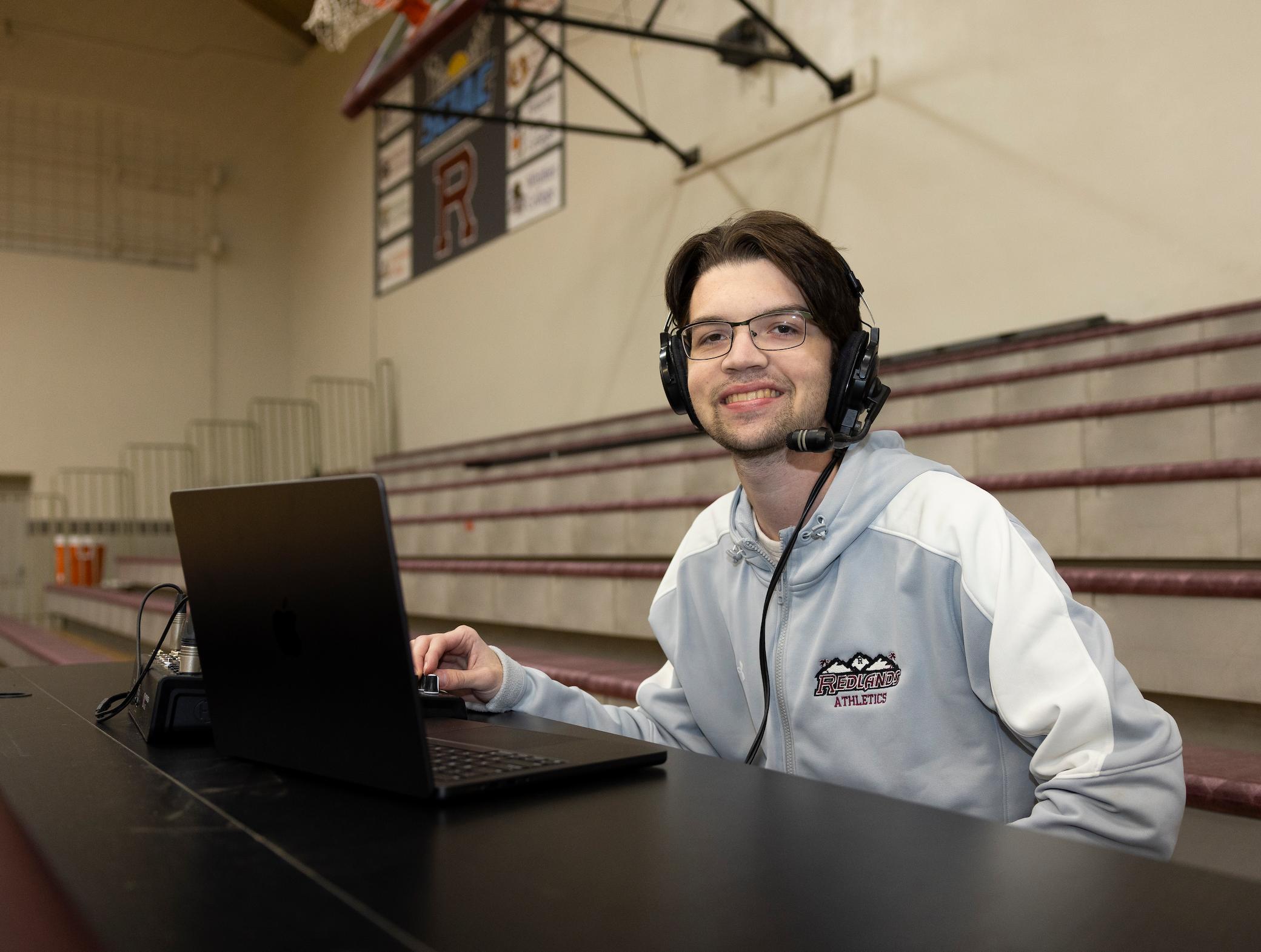 a person wearing headphones and using a laptop