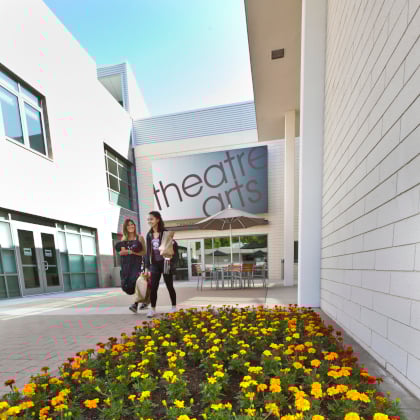 a group of women walking in a courtyard
