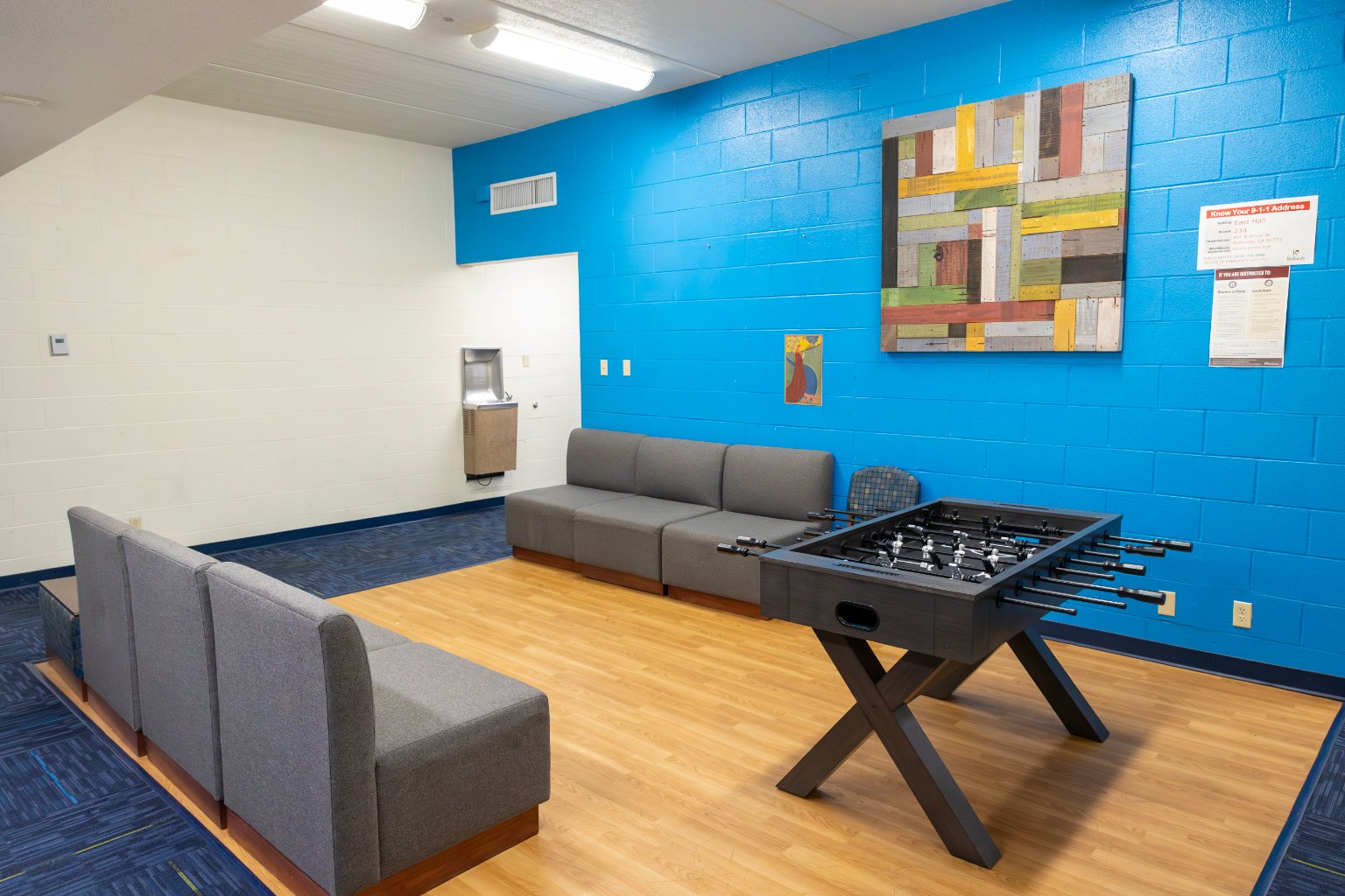 a room with a couch and foosball table