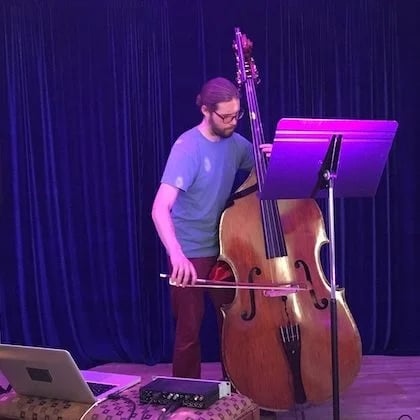 a person playing a double bass