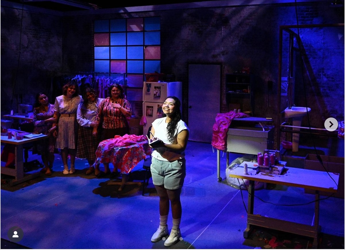 a person standing in a room with other people behind her