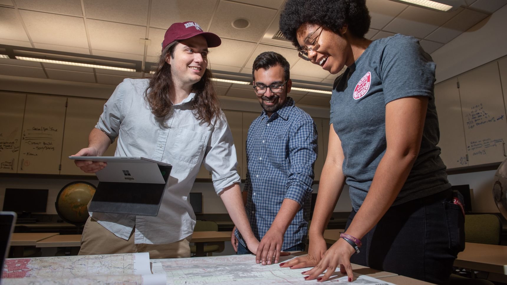 a group of people looking at a map