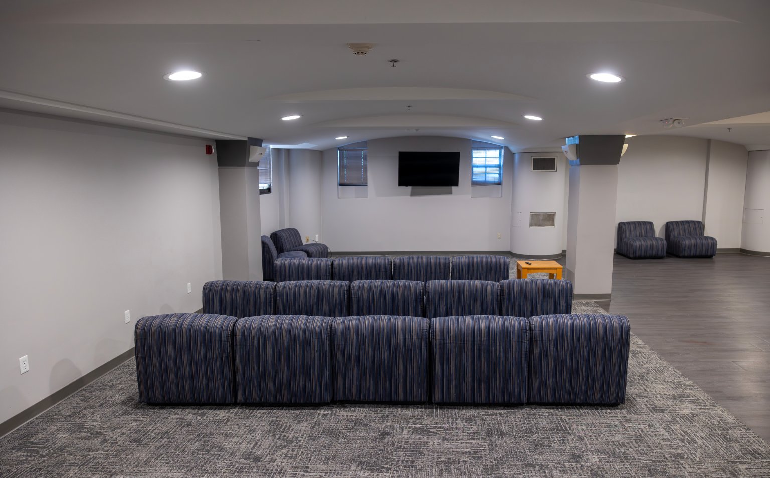 a room with blue and white striped couches