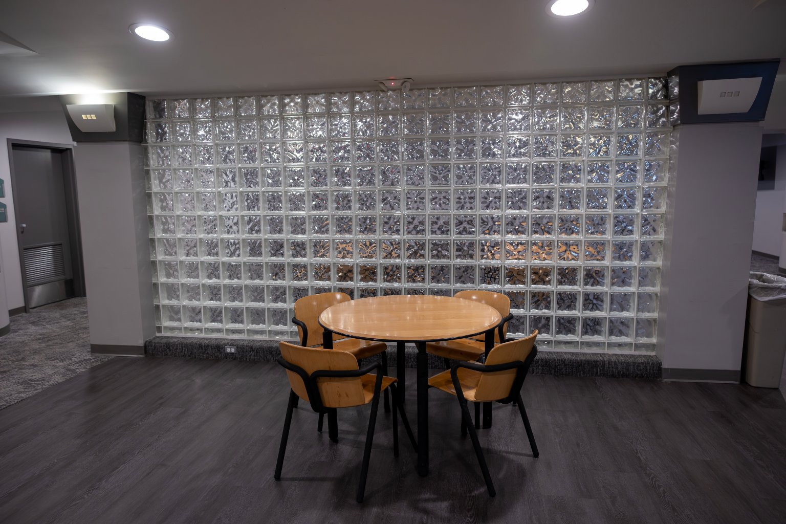 a table and chairs in a room with glass blocks