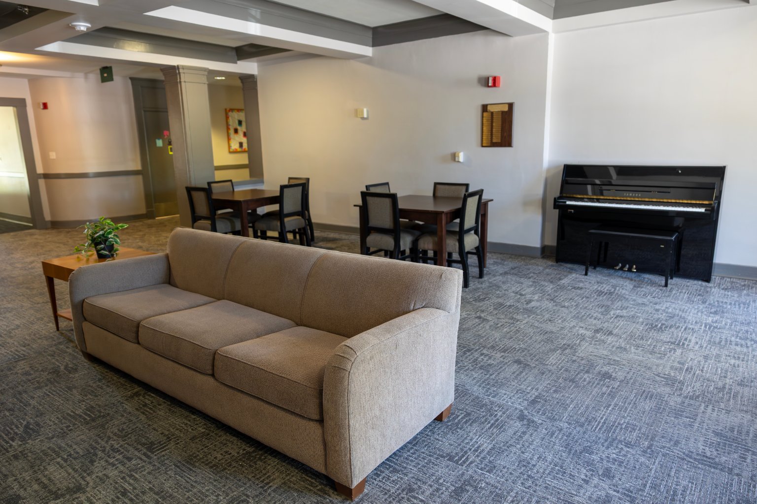 a couch and piano in a room