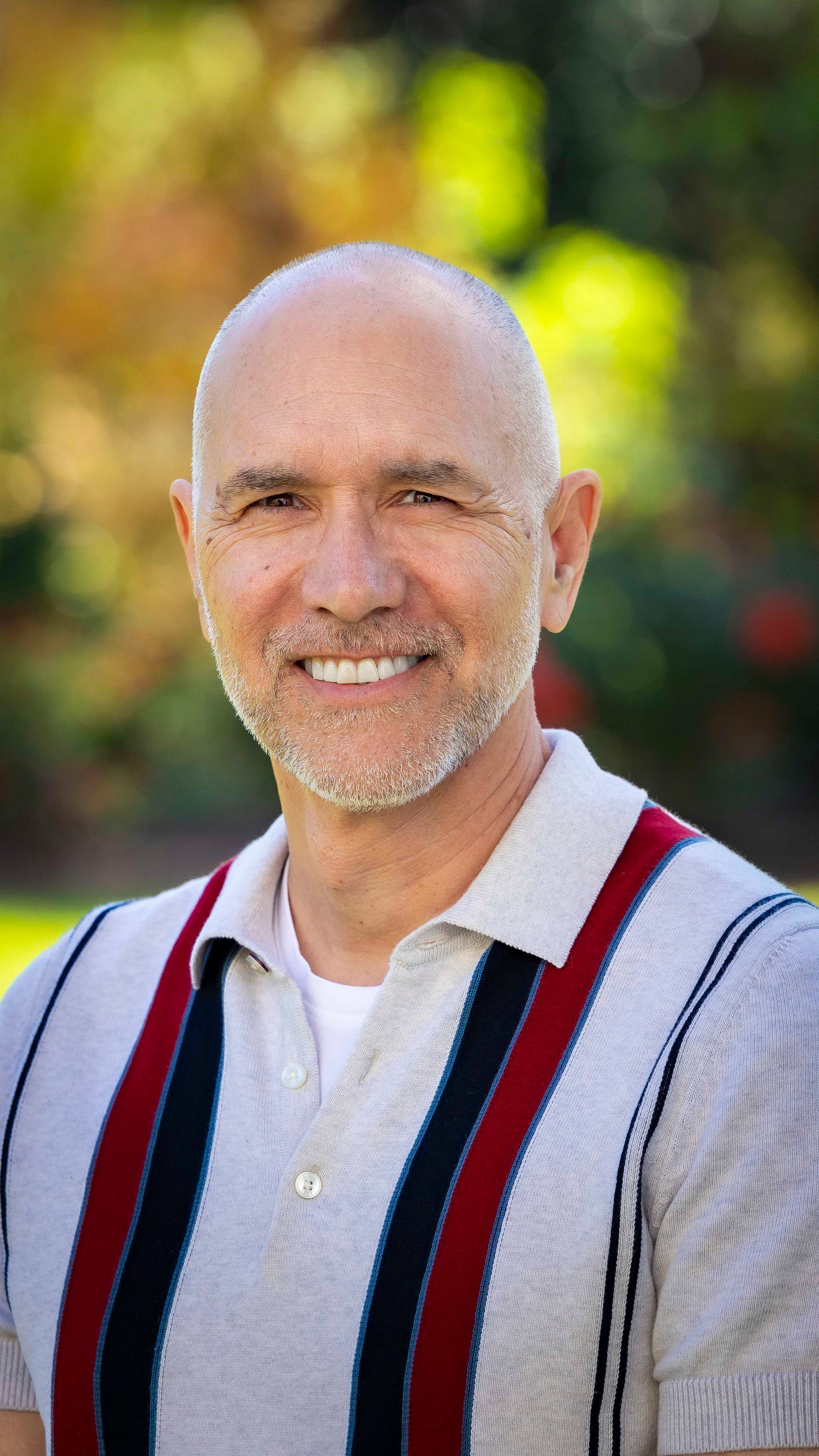 a person smiling with sand on his beard