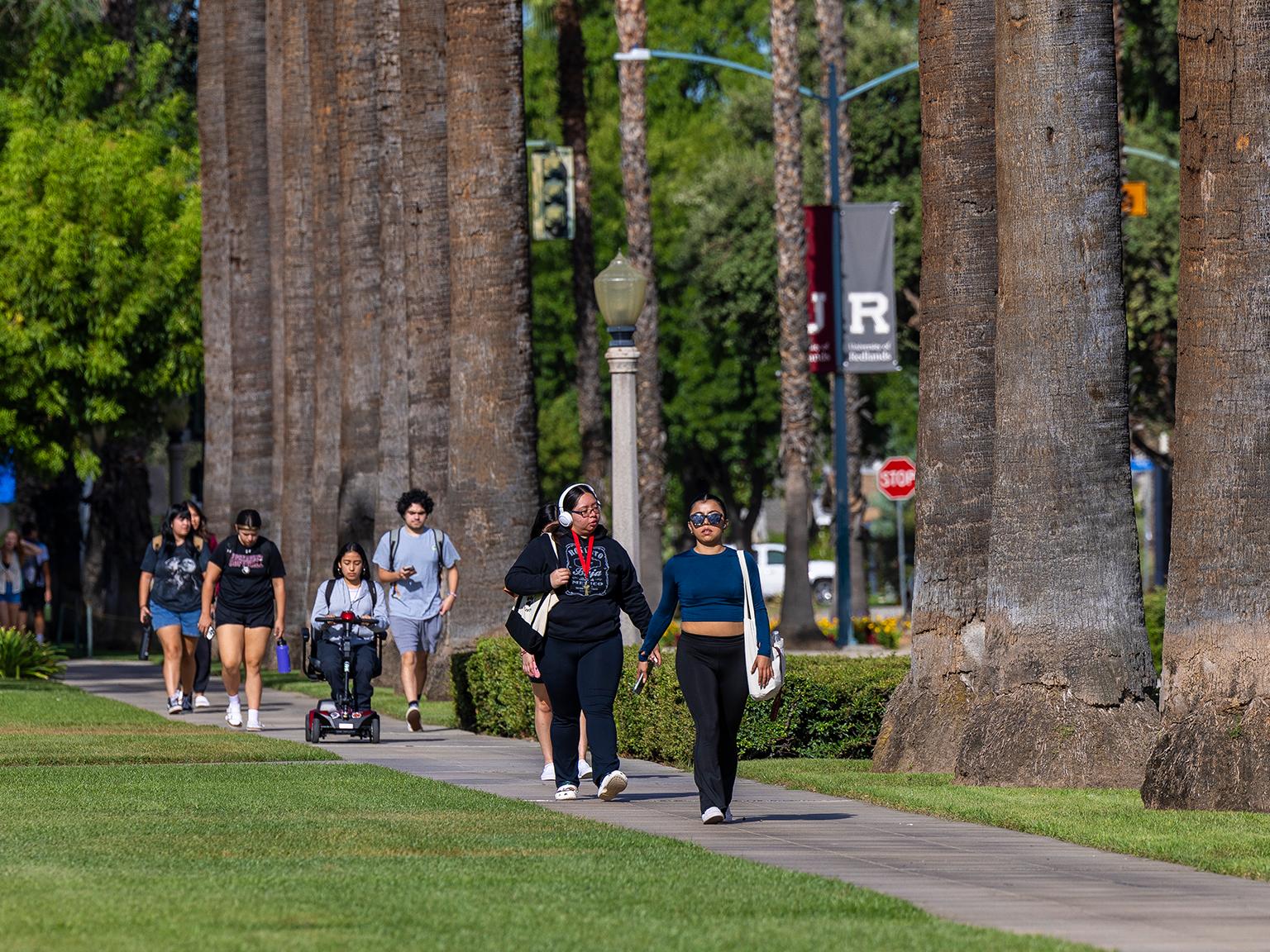 Students walking on the sidewalk at University of Redlands.