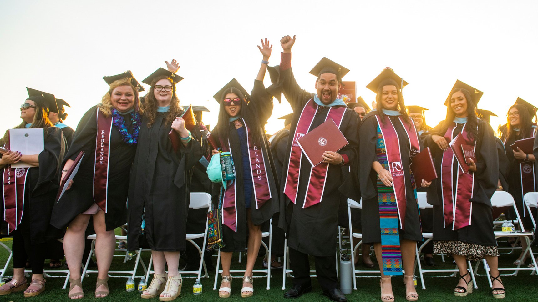 a group of people in graduation gowns and caps