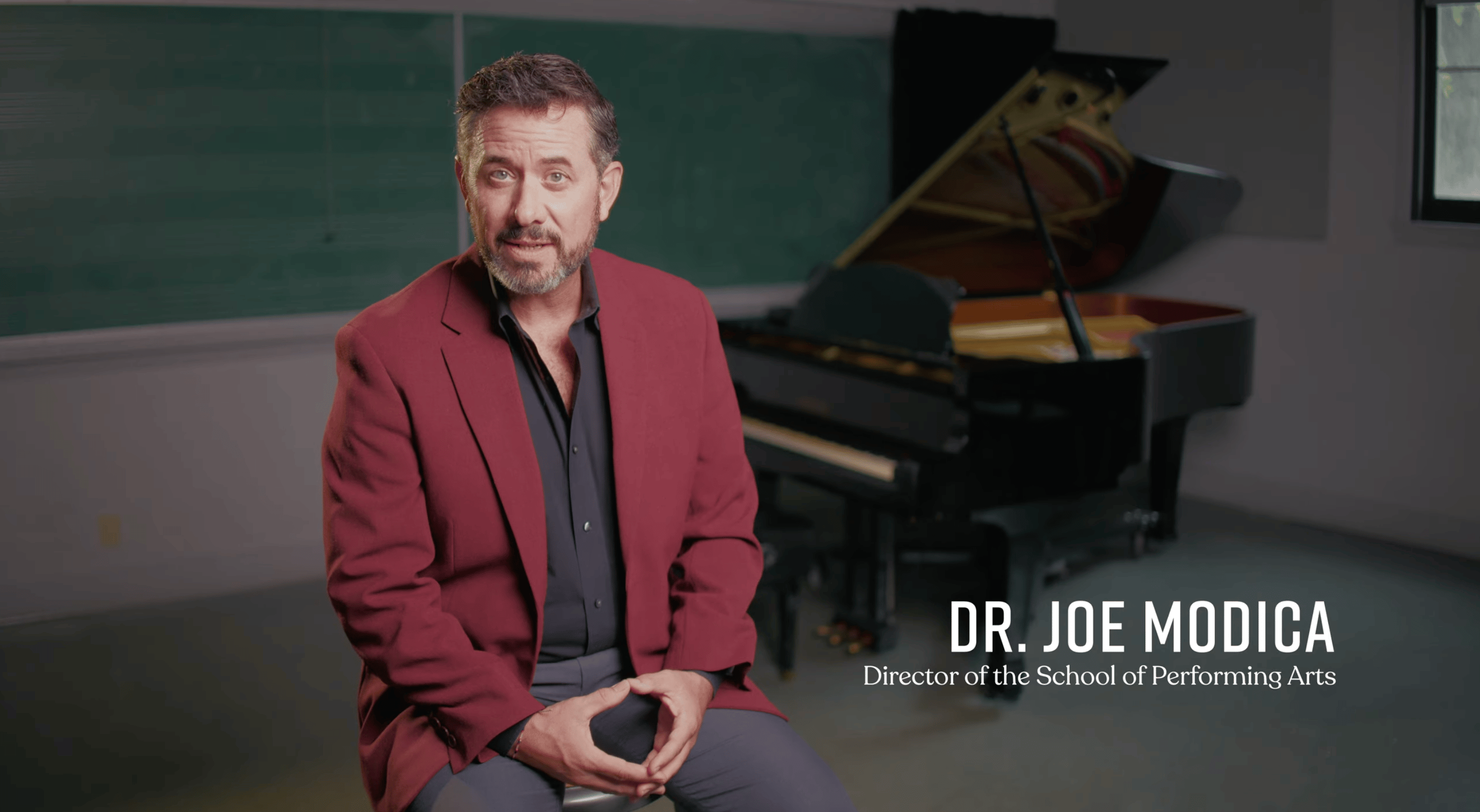 a person sitting in front of a piano