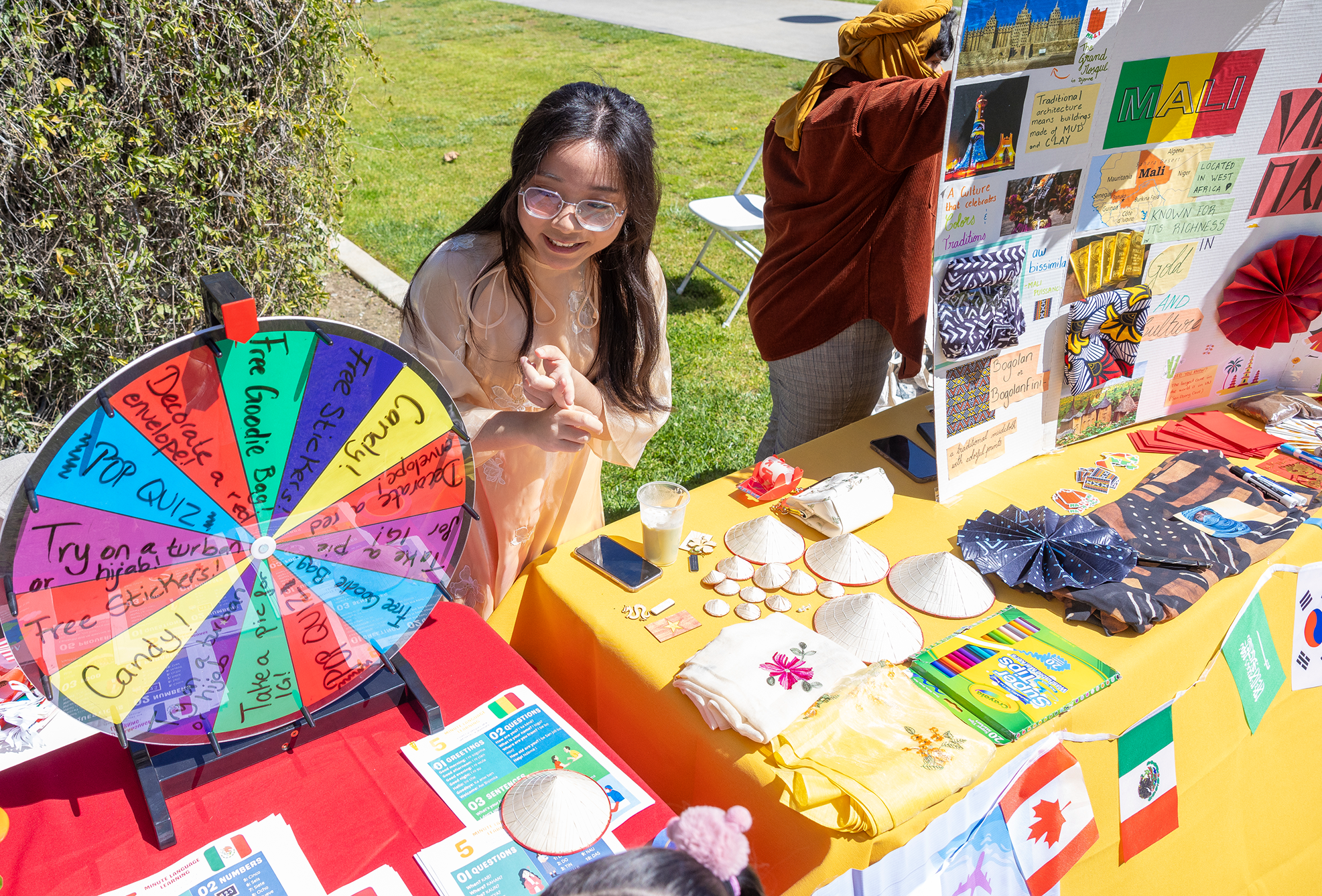 a person standing at a table with a wheel of paper and other objects