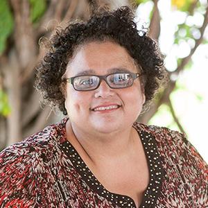 a person wearing glasses and a patterned shirt