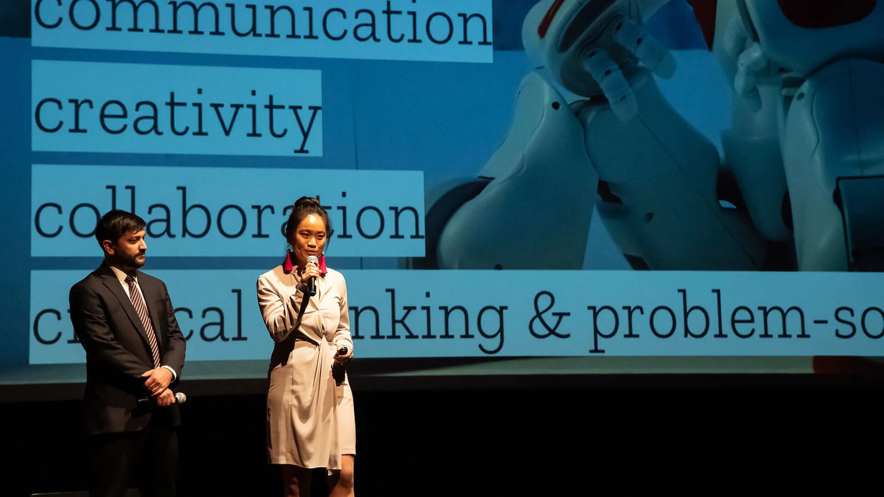 a woman on a stage holding a microphone