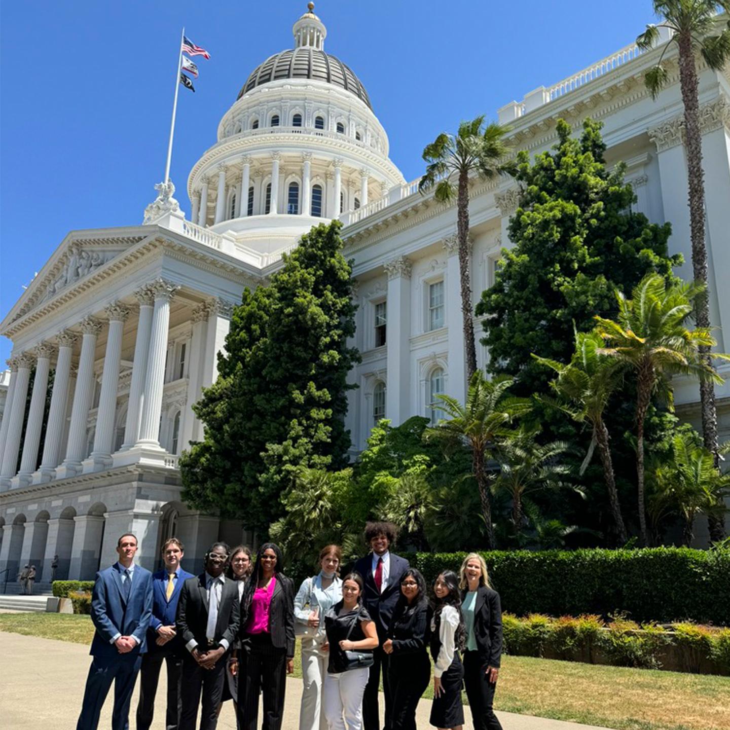 a group of people standing in front of a white building