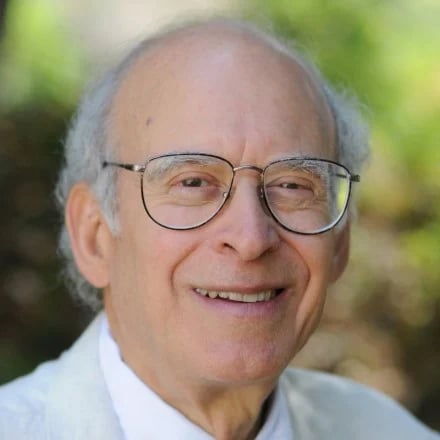 a person wearing glasses smiling