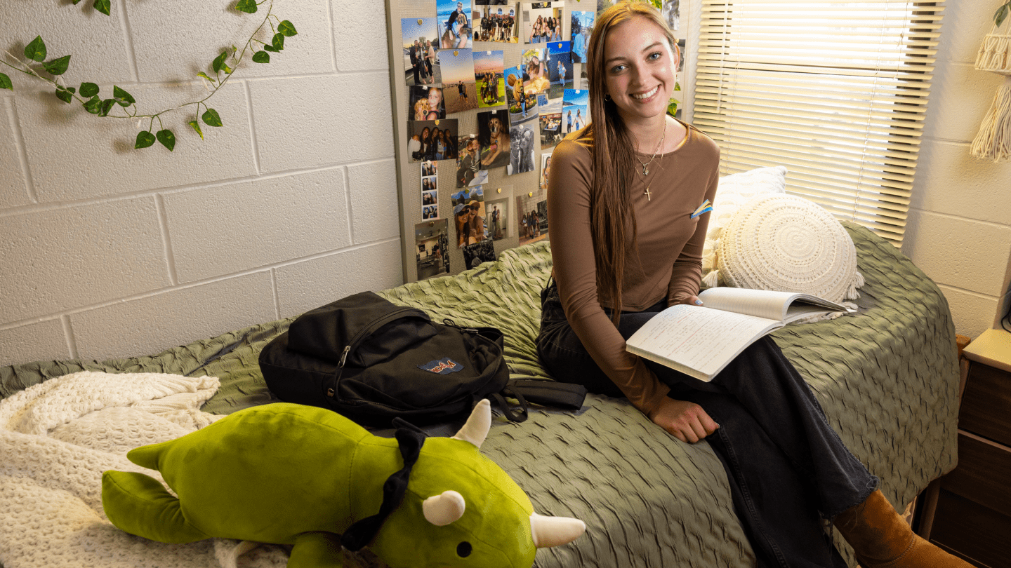 a person sitting on a bed with a stuffed animal